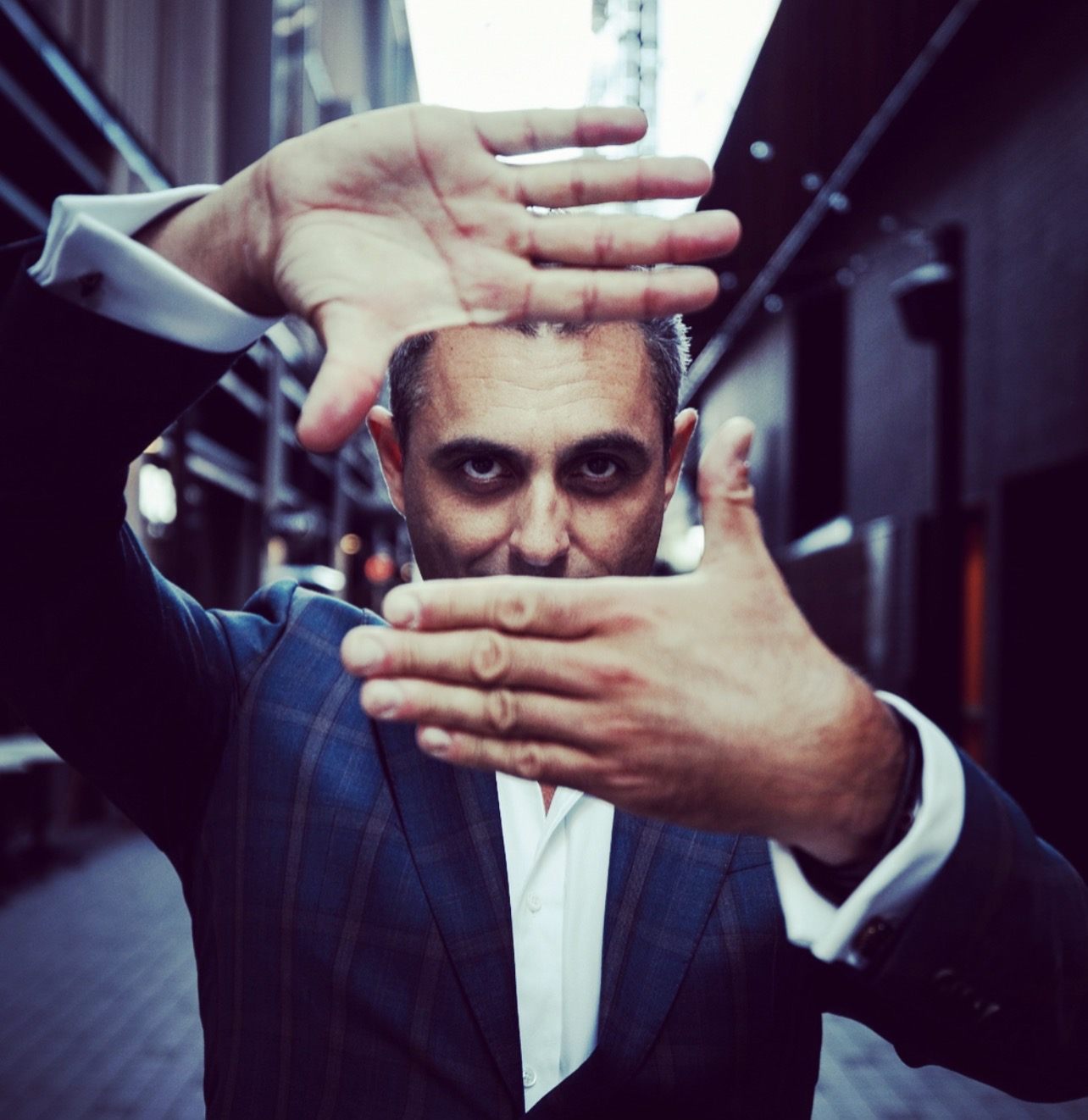Hands framing Phoenix’s head in a dramatic mind-reading portrait